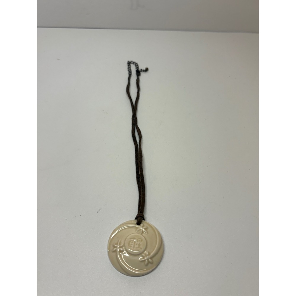 Unbranded Cream Round Embossed Floral Character Pendant Brown Cord Necklace